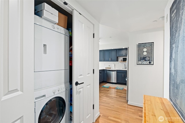 4116 California Ave SW Unit 309, Seattle, WA 98116 - laundry room featuring estacked washer and dryer and light wood finished floors
