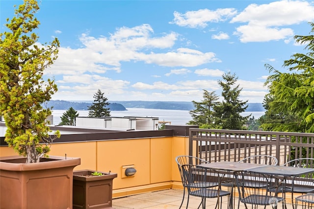 4116 California Ave SW Unit 309, Seattle, WA 98116 - view of patio with a water view and outdoor dining area