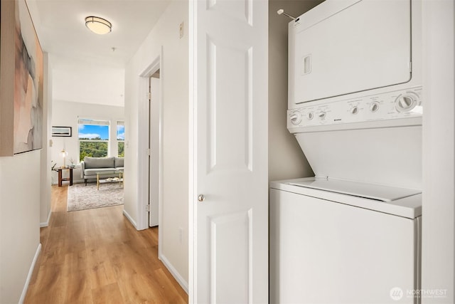 2101 N 55th St Unit 312, Seattle, WA 98103 - laundry area with estacked washer and dryer and light wood-type flooring