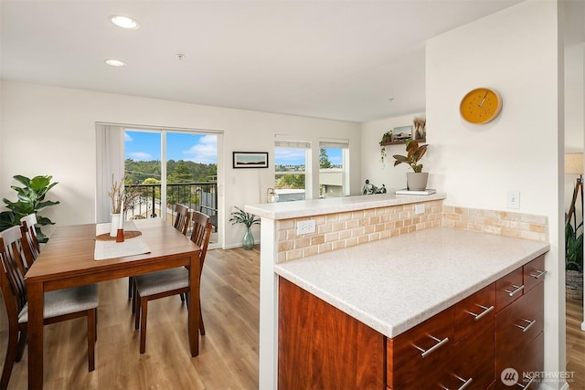 2101 N 55th St Unit 312, Seattle, WA 98103 - kitchen with light wood finished floors, light countertops, decorative backsplash, modern cabinets, and recessed lighting