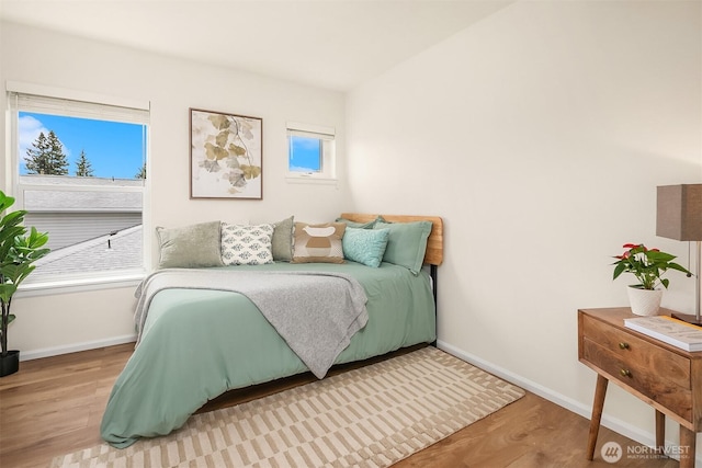 2101 N 55th St Unit 312, Seattle, WA 98103 - bedroom with baseboards and wood finished floors