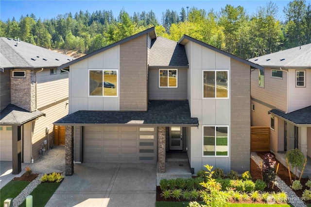 20837 156th St E, Bonney Lake, WA 98391 - modern home with board and batten siding, concrete driveway, an attached garage, and a shingled roof