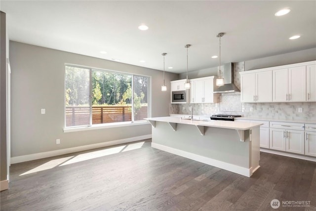 20837 156th St E, Bonney Lake, WA 98391 - kitchen featuring stainless steel microwave, wall chimney exhaust hood, light countertops, decorative backsplash, and white cabinetry