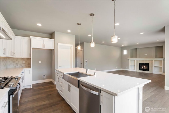 20837 156th St E, Bonney Lake, WA 98391 - kitchen featuring appliances with stainless steel finishes, dark wood-style flooring, white cabinets, light countertops, and recessed lighting