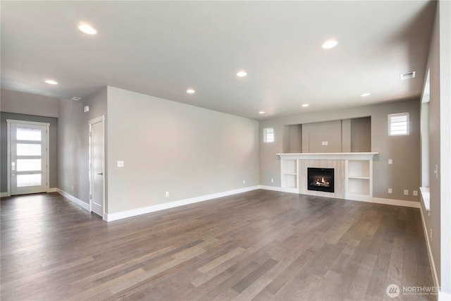 20837 156th St E, Bonney Lake, WA 98391 - unfurnished living room with plenty of natural light, dark wood-style floors, recessed lighting, and a tile fireplace
