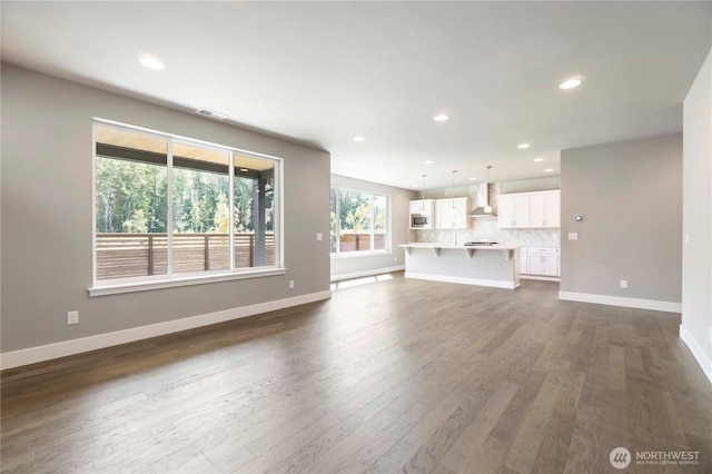 20837 156th St E, Bonney Lake, WA 98391 - unfurnished living room with dark wood-type flooring and recessed lighting