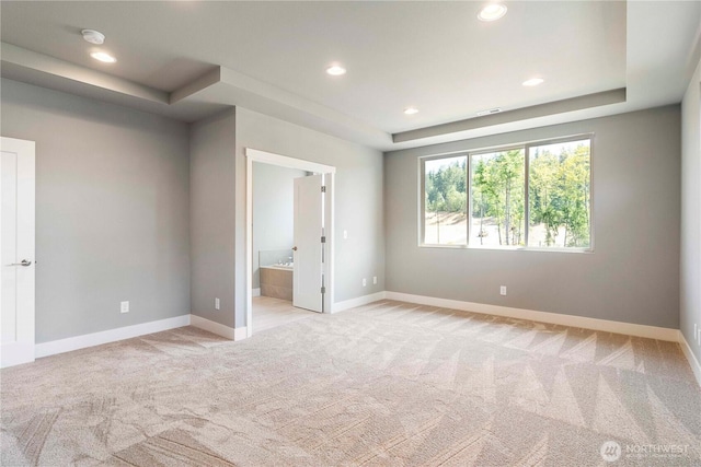 20837 156th St E, Bonney Lake, WA 98391 - unfurnished bedroom with light colored carpet, a tray ceiling, recessed lighting, and ensuite bathroom