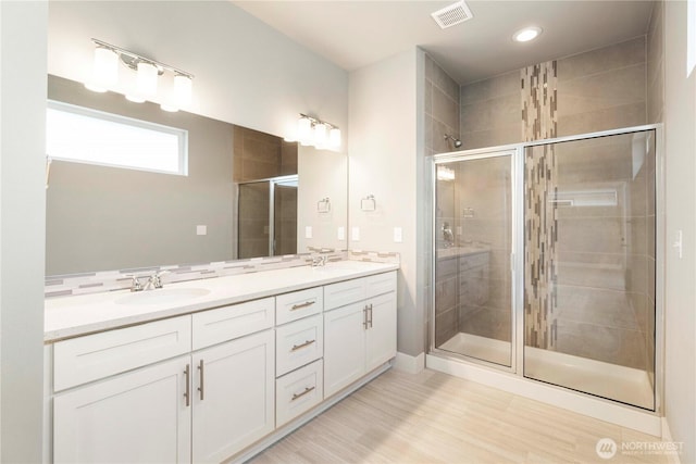 20837 156th St E, Bonney Lake, WA 98391 - bathroom with double vanity, a stall shower, wood finished floors, and recessed lighting