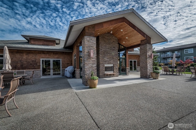 512 Darby Dr Unit 213, Bellingham, WA 98226 - back of property with french doors, a patio area, stone siding, and outdoor dining area