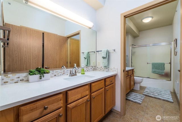512 Darby Dr Unit 213, Bellingham, WA 98226 - bathroom with vanity, decorative backsplash, enclosed tub / shower combo, and tile patterned floors