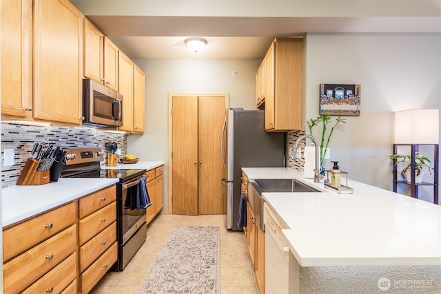 512 Darby Dr Unit 213, Bellingham, WA 98226 - kitchen with stainless steel appliances, decorative backsplash, a peninsula, light countertops, and light brown cabinets