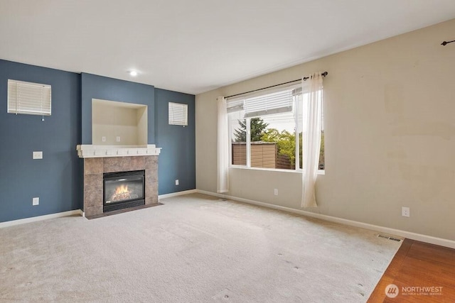 1353 32nd Pl NE, Auburn, WA 98002 - unfurnished living room with baseboards and a tiled fireplace