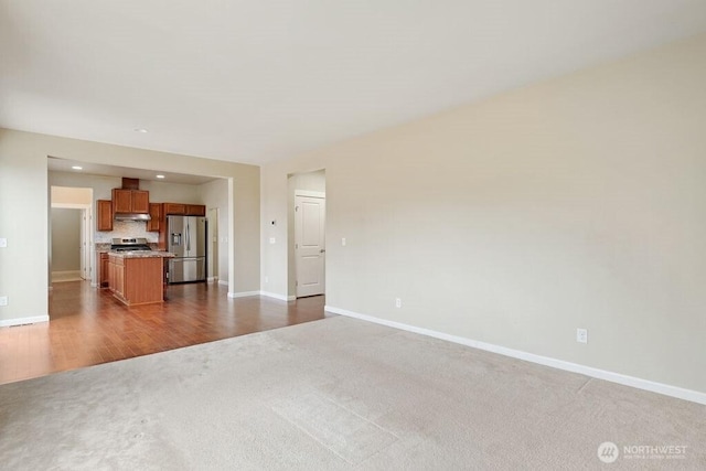 1353 32nd Pl NE, Auburn, WA 98002 - unfurnished living room with carpet, recessed lighting, and wood finished floors