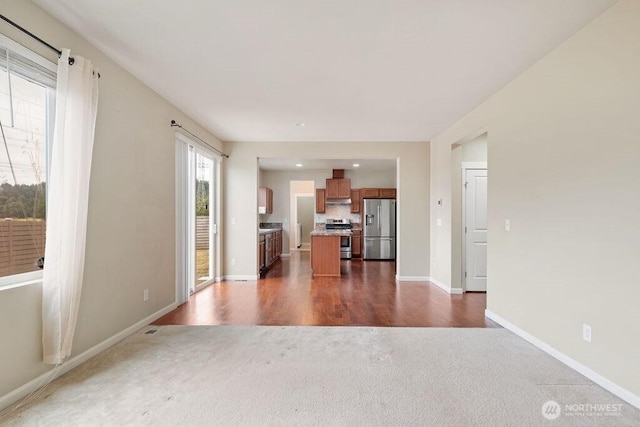 1353 32nd Pl NE, Auburn, WA 98002 - unfurnished living room with dark carpet, dark wood-style flooring, and recessed lighting