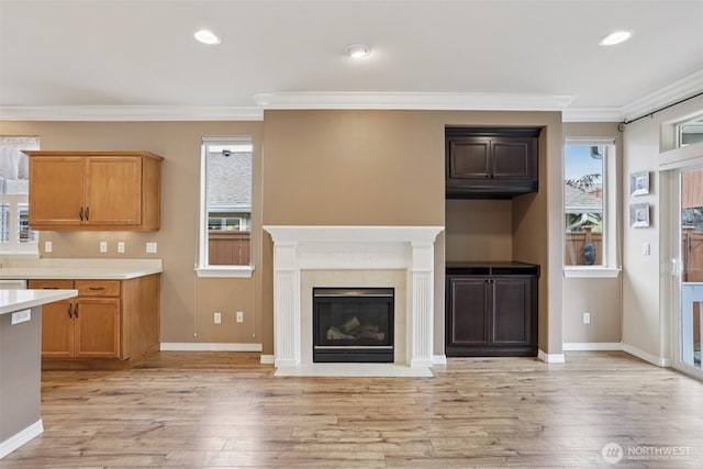 4826 Bend Dr NE, Lacey, WA 98516 - unfurnished living room featuring plenty of natural light, crown molding, light wood finished floors, a fireplace with flush hearth, and recessed lighting
