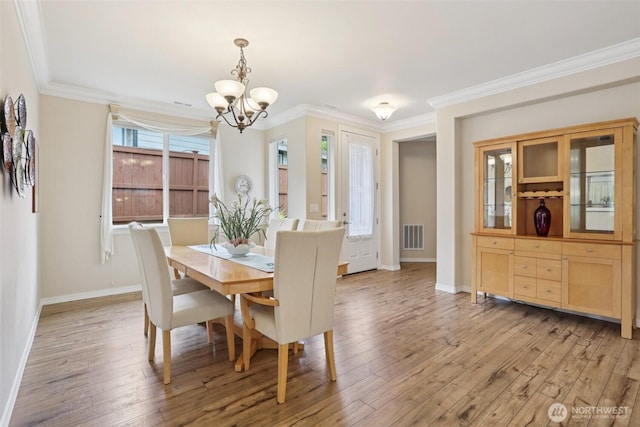 4826 Bend Dr NE, Lacey, WA 98516 - dining room with a chandelier, light wood finished floors, and ornamental molding