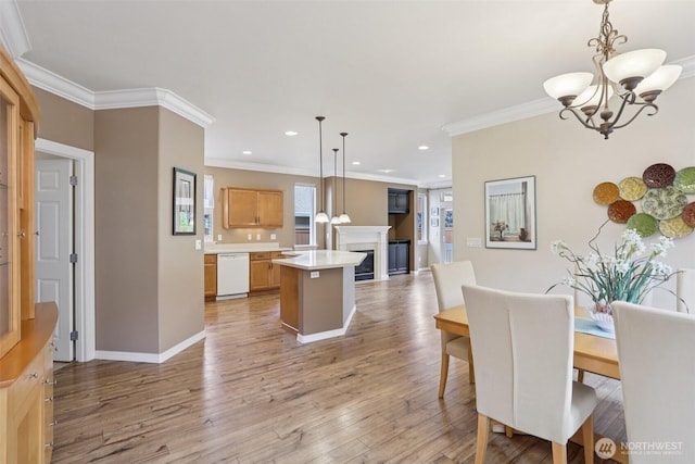 4826 Bend Dr NE, Lacey, WA 98516 - dining space featuring a chandelier, crown molding, a fireplace, recessed lighting, and light wood-style floors