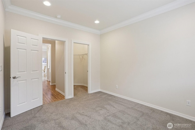4826 Bend Dr NE, Lacey, WA 98516 - unfurnished bedroom with carpet flooring, crown molding, a spacious closet, and recessed lighting