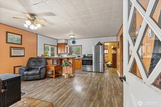 30710 223rd Ave NE, Arlington, WA 98223 - kitchen with stainless steel appliances, dark wood-style flooring, brown cabinets, ceiling fan, and light countertops