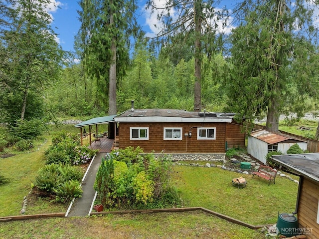 30710 223rd Ave NE, Arlington, WA 98223 - rear view of property with a yard, an outdoor structure, and a wooded view