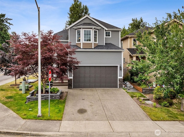 7726 162nd St E, Puyallup, WA 98375 - traditional-style home with concrete driveway, a garage, stone siding, a front yard, and roof with shingles