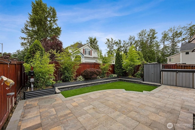 7726 162nd St E, Puyallup, WA 98375 - fenced backyard with a patio and a storage unit
