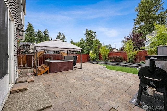 7726 162nd St E, Puyallup, WA 98375 - fenced backyard with a hot tub, a patio area, area for grilling, and a gazebo