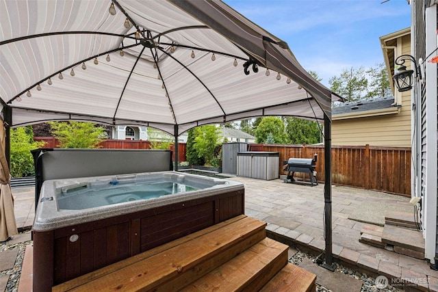 7726 162nd St E, Puyallup, WA 98375 - wooden terrace featuring a hot tub, a gazebo, a patio area, and a fenced backyard