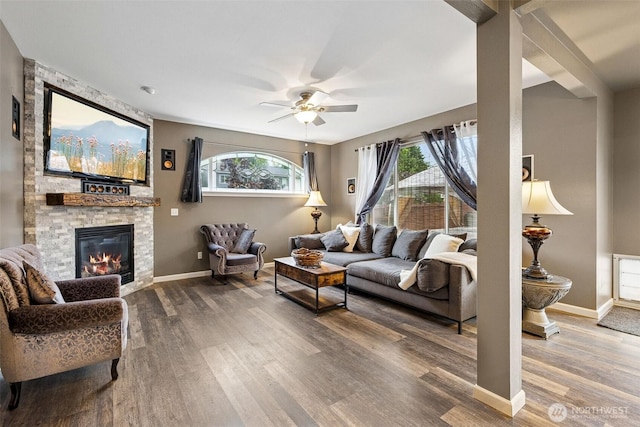 7726 162nd St E, Puyallup, WA 98375 - living room with wood finished floors, a ceiling fan, and a fireplace