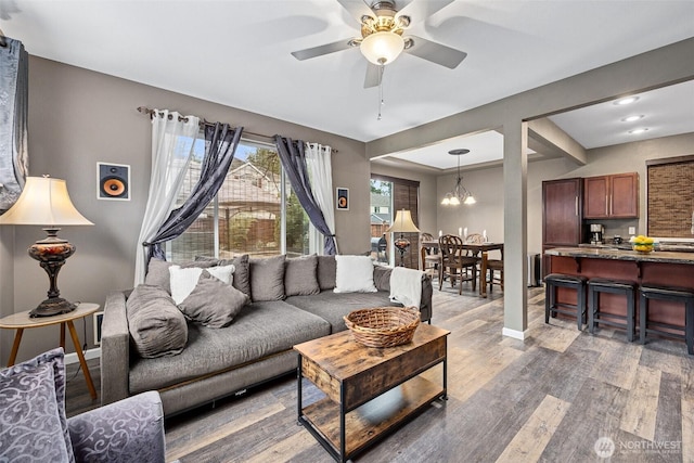 7726 162nd St E, Puyallup, WA 98375 - living room featuring light wood-style flooring, ceiling fan, and a chandelier