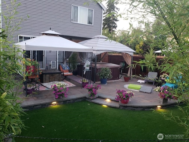 7726 162nd St E, Puyallup, WA 98375 - back of house featuring a hot tub, a gazebo, a deck, and a patio area
