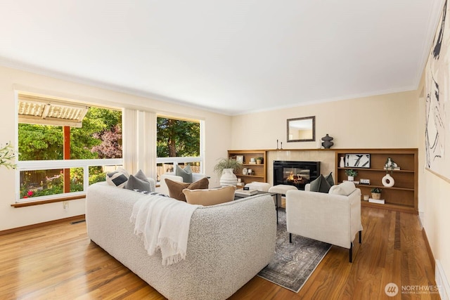 132 NE 130th St, Seattle, WA 98125 - living area with wood finished floors, crown molding, and a glass covered fireplace