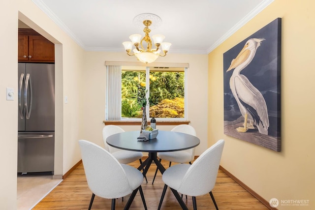 132 NE 130th St, Seattle, WA 98125 - dining room with a chandelier, light wood finished floors, and crown molding