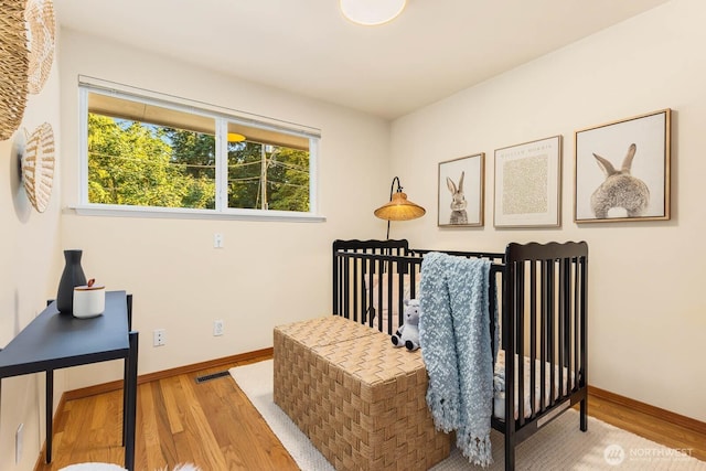 132 NE 130th St, Seattle, WA 98125 - bedroom featuring wood finished floors and multiple windows