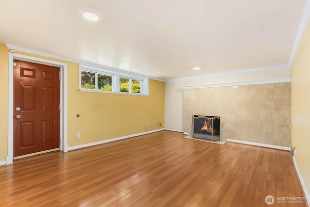 132 NE 130th St, Seattle, WA 98125 - unfurnished living room with a tiled fireplace, light wood finished floors, and crown molding