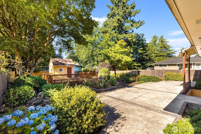 132 NE 130th St, Seattle, WA 98125 - fenced backyard featuring a wooden deck and a patio