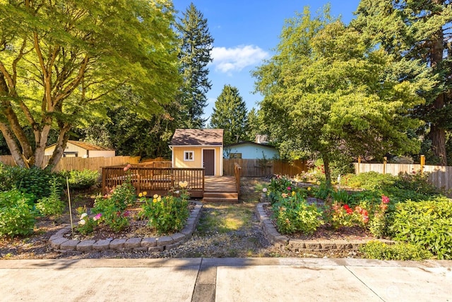 132 NE 130th St, Seattle, WA 98125 - view of front of house with a deck, a fenced backyard, and a storage shed