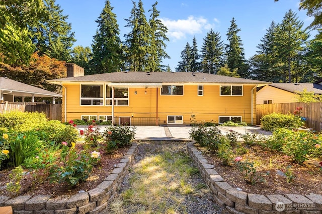 132 NE 130th St, Seattle, WA 98125 - back of house featuring a patio and a chimney