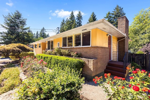 132 NE 130th St, Seattle, WA 98125 - view of front of house with a chimney and brick siding