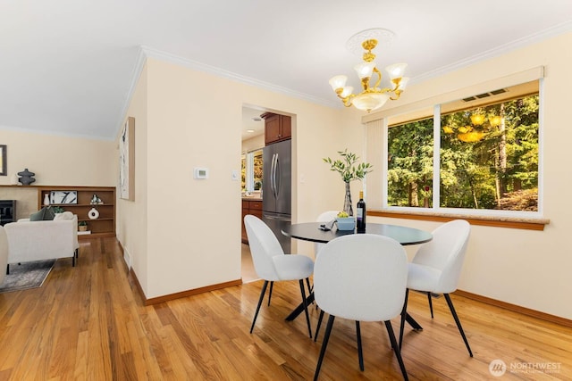 132 NE 130th St, Seattle, WA 98125 - dining area with a chandelier, crown molding, and light wood-style floors