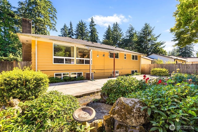 132 NE 130th St, Seattle, WA 98125 - back of property featuring a chimney and a patio area