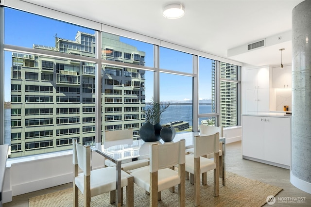 2033 2nd Ave Unit 1111, Seattle, WA 98121 - dining area with a water view, light wood-style floors, and plenty of natural light