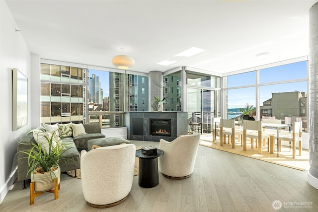 2033 2nd Ave Unit 1111, Seattle, WA 98121 - living area with wood finished floors, plenty of natural light, floor to ceiling windows, and a lit fireplace