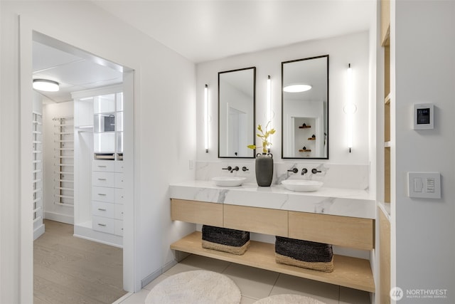 2033 2nd Ave Unit 1111, Seattle, WA 98121 - full bath with double vanity, a walk in closet, and wood finished floors