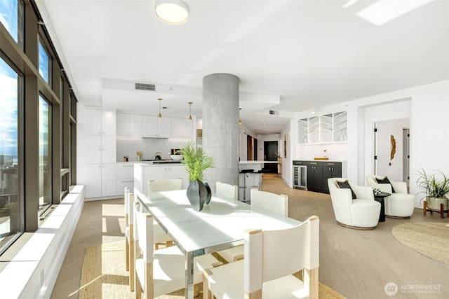 2033 2nd Ave Unit 1111, Seattle, WA 98121 - dining area featuring light wood finished floors and beverage cooler