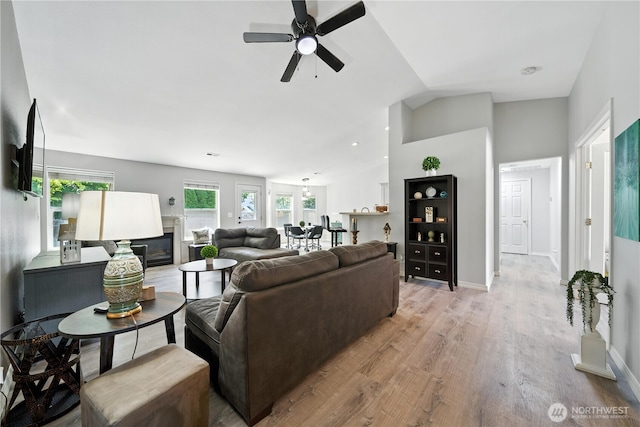 2322 Garrison St, Walla Walla, WA 99362 - living room featuring ceiling fan, light wood-style flooring, vaulted ceiling, and a glass covered fireplace