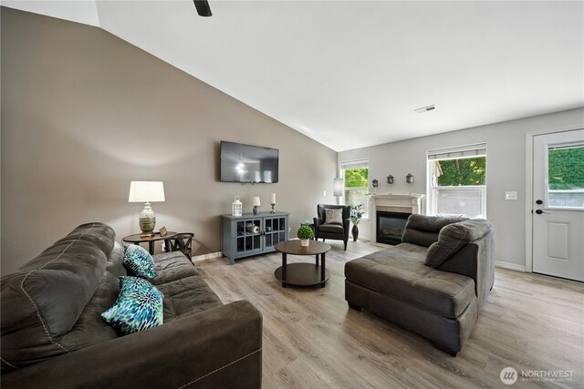 2322 Garrison St, Walla Walla, WA 99362 - living room featuring light wood-style floors, a fireplace with flush hearth, and lofted ceiling