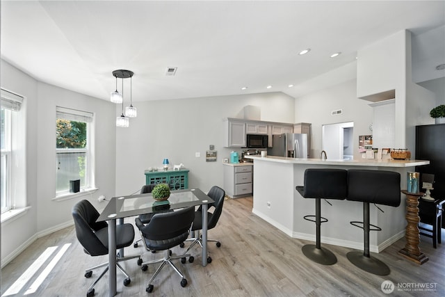 2322 Garrison St, Walla Walla, WA 99362 - dining room with light wood-type flooring, vaulted ceiling, and recessed lighting