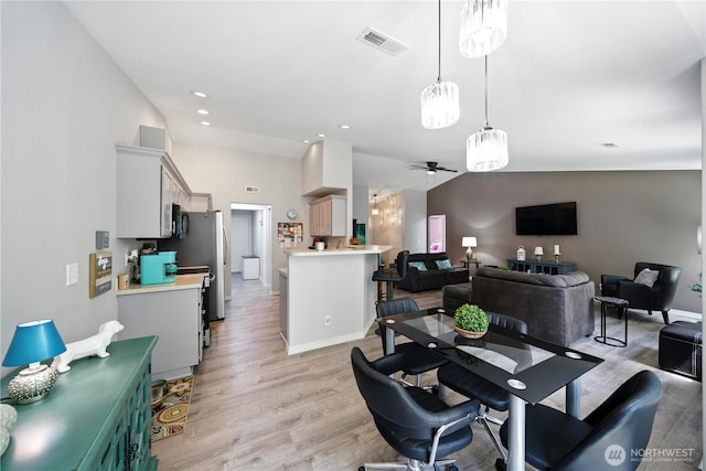 2322 Garrison St, Walla Walla, WA 99362 - dining area featuring vaulted ceiling, ceiling fan, light wood finished floors, and recessed lighting