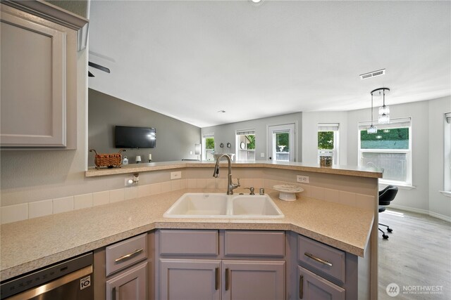 2322 Garrison St, Walla Walla, WA 99362 - kitchen featuring stainless steel dishwasher, gray cabinetry, light countertops, pendant lighting, and vaulted ceiling